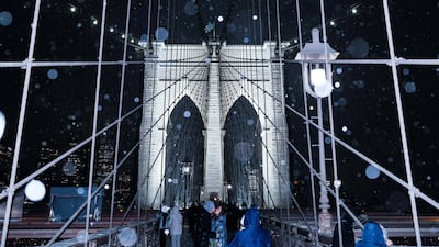 A couple kiss on the Brooklyn Bridge in New York City. Reuters