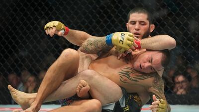 Islam Makhachev attempts to submit Dustin Poirier during the first round of their fight at UFC 302. AP