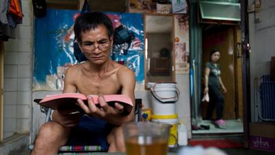 Ms Su’s neighbour Quang Xuan, 55, a refugee from Vietnam who works as a handyman and has lived in his rooftop home for 10 years. Anthony Wallace/AFP Photo