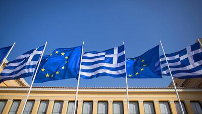 The national flag of Greece and the flag of the European Union fly above a government building in Athens. Matt Cardy / Getty Images