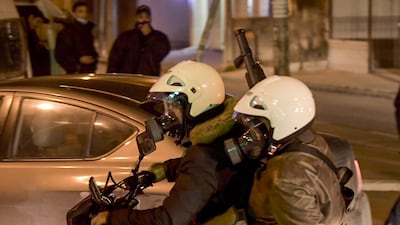 Tunisian security forces members wearing civilian clothing ride a motorcycle while one carries anti-riot arms ahead of clashes with protesters in the Ettadhamen city suburb on the northwestwern outskirts of Tunisia's capital Tunis amidst a wave of nightly protests in the North African country. AFP