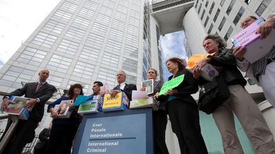 Members of Survivors Network of those Abused by Priests (SNAP), from left: Peter Isely, Rita Milla, Emmanuel Henckens, Phil Saviano, Megan Peterson, Barbara Blaine, Bert Smeets and Winfried Fesselmann pose in front of the International Criminal Court in The Hague yesterday.