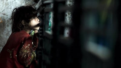 A child watches as people receive free food at the shrine of Bari Imam on the outskirts of Islamabad, Pakistan. Caren Firouz / Reuters