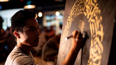This photo taken on June 22, 2019 shows artist Taipan Lucero doing calligraphy using the indigenous script known as Baybayin, used before Spanish colonisation in 1521, at an event in Manila. Photos: AFP / Noel Celis