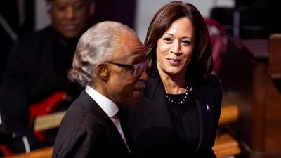 Mr Harris joins Rev Sharpton during the funeral service. AP