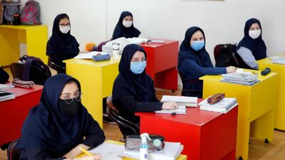 Iranian high school girls wearing face masks attend a class on the first day of reopening the Bamdad Parsi private school, north of Tehran, Iran. EPA