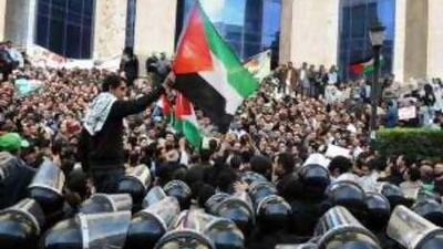 Egyptian anti-riot policemen surround activists protesting against the Israeli attacks in Cairo.