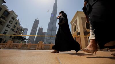 Women walk past the Burj Khalifa in Dubai, United Arab Emirates, June 11. Reuters