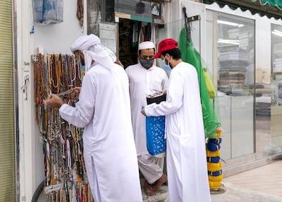 Customers shop for Eid Al Fitr in the Baniyas souq in Abu Dhabi. Reem Mohammed / The National