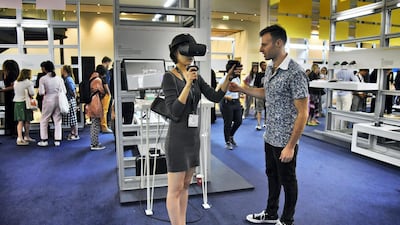An exhibitor, right, explains his project to a woman attending the Global Grad Show during the Dubai Design Week at the Dubai Design District, Dubai, UAE, on Monday, Nov. 11, 2019. (Photos by Shruti Jain - The National)