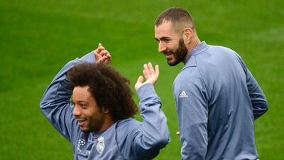 Real Madrid’s Marcelo, left, gestures past Karim Benzema during training. Pierre-Philippe Marcou / AFP