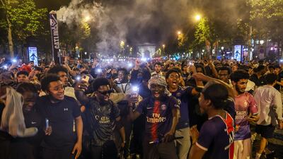 Fans of PSG celebrate on the Champs-Elysees. EPA