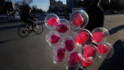 An Afghan street vendor waits for customers before Valentine's Day in Kabul. AP
