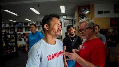 Manny Pacquiao talks to trainer Freddie Roach after an afternoon training session at Wild Card Boxing in Los Angeles. AFP