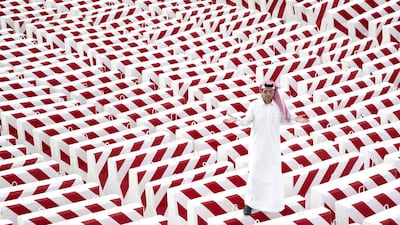The artist Abdulnassesr Gharem with his concrete blocks installation. Courtesy of Abdulnasser Gharem / Edge of Arabia