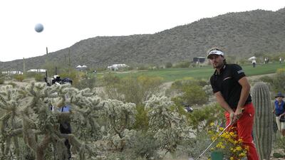 Victor Dubuisson of France takes a shot out of the desert on February 23, 2014, on the 20th hole in his championship match against Jason Day of Australia, during the Match Play Championship golf tournament in Marana, Arizona. Day won after 23 holes. Ted S. Warren / AP photo