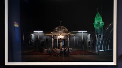 The mosque made of industrial material lights up at night