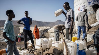 Sudanese refugees wait in line to collect water at Kumer refugee camp in Ethiopia's Amhara region. Refugees face conflict and insecurity as the border region of Amhara is plagued by unrest and clashes in which the Ethiopian army is battling an ethnic Amhara militia known as Fano. AFP