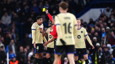 Barcelona's Ronald Araujo, left, is shown a yellow card by referee Slavko Vincic during the Uefa Champions League, league phase match against Chelsea at Stamford Bridge. The Uruguayan would later receive a second yellow card just before half time to reduce Barca to 10 men. PA