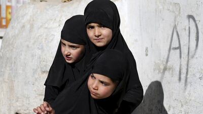 Afghan girls stand at the site of a suicide attack in Kabul. Mohammad Ismail / Reuters