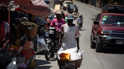 A man pushes a wheelbarrow in Port-au-Prince, Haiti. A 7.2-magnitude earthquake struck the country on Saturday.