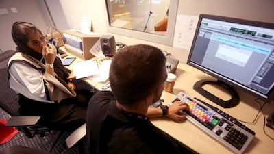 Futaim Al Falasi, left, and Yazen Bakjaji, an audio engineer, record a podcast of Taim Show in Abu Dhabi. Sammy Dallal / The National
