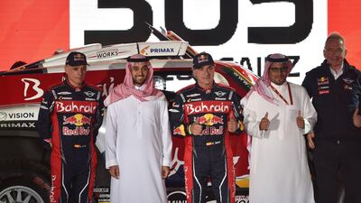 Bahrain JCW X-Raid Team's Spanish driver Carlos Sainz (C) and his Spanish co-driver Lucas Cruz pose for a picture during the podium ceremony in Jeddah. AFP
