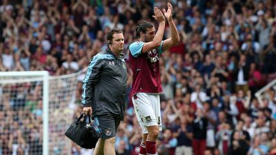West Ham's English striker Andy Carroll applauds the supporters as he's substituted following an injury against Fulham. Andrew Cowie/AFP