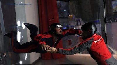 Visitors try the exhilarating iFLY experience at iFLYDubai at the Mirdiff City Centre . Satish Kumar / The National