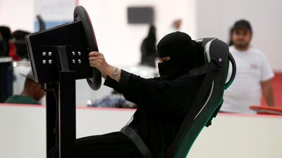A Saudi woman tries a car simulator during women car show in Riyadh, Saudi Arabia May 13, 2018. REUTERS/Faisal Al Nasser