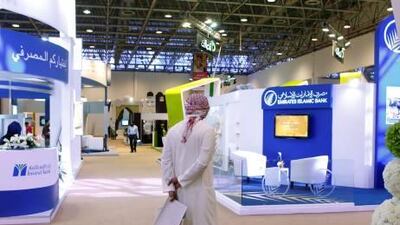 A man explores employment opportunities in the banking sector at the Emirati jobs fair at the Sharjah Expo Centre.