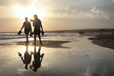 People walk along the beach in Sampieri in Sicily, which is now connected to Dubai by low-cost flights. AFP