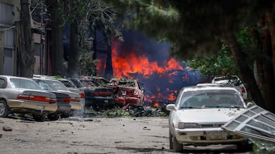 Fire takes hold and cars lie wrecked by the shockwaves.