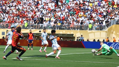 Spain's Lamine Yamal sees his defelcted shot saved by Argentina goalkeeper Emiliano Martinez. Reuters