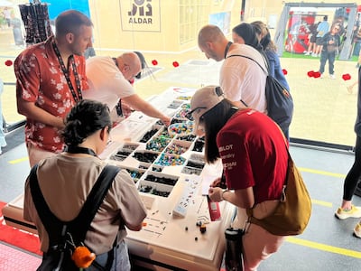 Families building mini Formula One cars at the Lego pop-up in the Fanzone during Family Friday at Yas Marina Circuit. Faisal Al Zaabi / The National