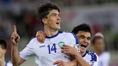 Eldor Shomurodov of Uzbekistan celebrates scoring. EPA
