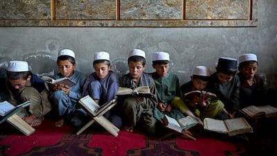 Afghan children read the Quran at a madrassa in Yaftal Sufla district, Badakhshan province. AFP