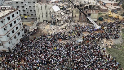 Rescuers look for survivors and victims amid the rubble of the Rana Plaza compound in Savar, near Dhaka, on April 25, 2013, a day after the building collapsed. A M Ahad / AP Photo