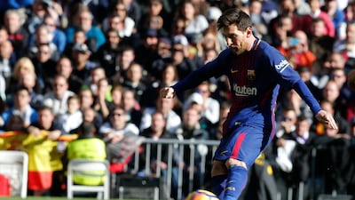 Barcelona's Lionel Messi scores from a penalty kick during a Spanish La Liga soccer match between Real Madrid and Barcelona at the Santiago Bernabeu stadium in Madrid, Spain, Saturday, Dec. 23, 2017. (AP Photo/Paul White)