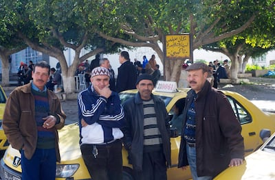 Taxi drivers wait for customers in Mateur, an industrial town near Tunis, in 2021. Aziz Tnani for The National