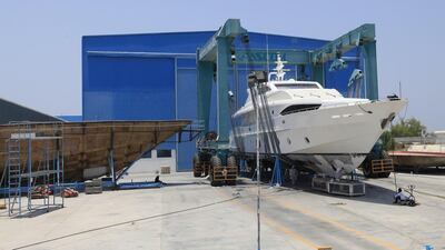 A yacht is lifted to be serviced at the Gulf Craft factory in Umm Al Quwain. Sarah Dea / The National