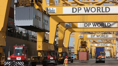 Gantries load cargo containers on trucks at Terminal 1 in Jebel Ali port in Dubai. Pawan Singh / The National