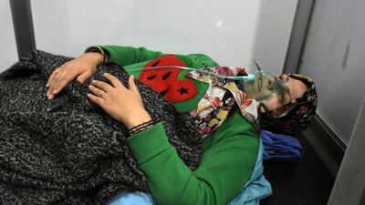 In this photo released by the Syrian official news agency SANA, shows a woman receiving oxygen through respirators following a suspected chemical attack on her town of al-Khalidiya, in Aleppo, Syria, Saturday, Nov. 24, 2018. Some 50 civilians were being treated following a suspected poison gas attack by Syrian rebel groups on the government-held Aleppo city in the country's north, according to Syrian state media. (SANA via AP)