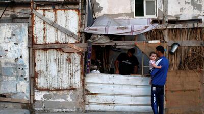 A Palestinian man repairs stoves in a makeshift shop amid the coronavirus crisis, at the beach refugee camp in Gaza City. Reuters