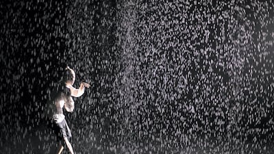 Rain Room is an immersive installation that invites visitors to walk through a downpour of continuous rain without getting wet, thanks to a system of networked 3D tracking cameras. Photo by Reem Mohammed / The National