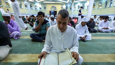 The Quran is read at Bani Hashim Mosque. Victor Besa / The National