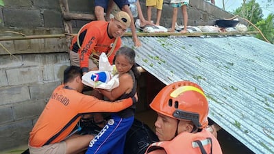 A woman and baby are rescued from Tropical Storm Trami in the Philippines. Scientists say climate change could reverse decades of progress in protecting newborns and their mothers. AP