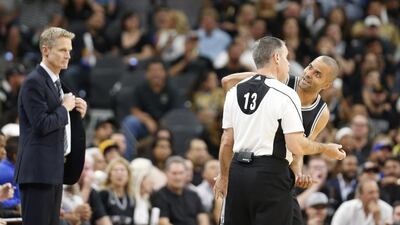 Tony Parker of the San Antonio Spurs argues a call with Monty McCutcheon as Golden State Warriors head coach Steve Kerr watches at AT&T Center on April 10, 2016 in San Antonio, Texas. Ronald Cortes/Getty Images/AFP