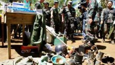 Soldiers inspect recovered medical and personal belongings after capturing Camp Bilal in Poona Piagapoin Mindanao, the former base of Abdurahman Macapaar, one of the top leaders of the Moro Islamic Liberation Front.