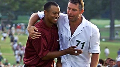 Tiger Woods celebrates with caddy Steve Williams after sealing victory. AFP